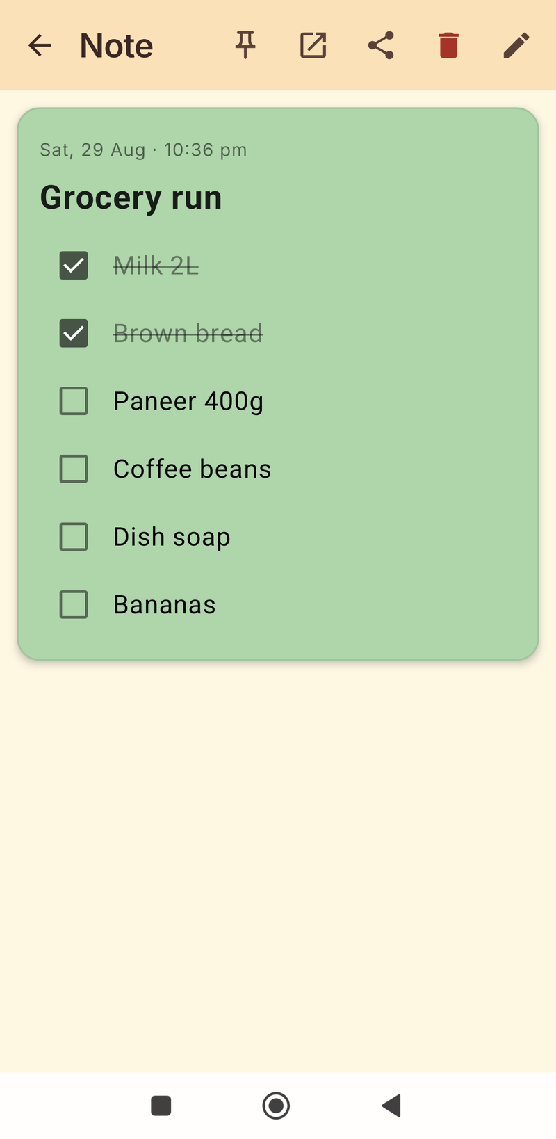 Green grocery checklist with two items ticked and struck through